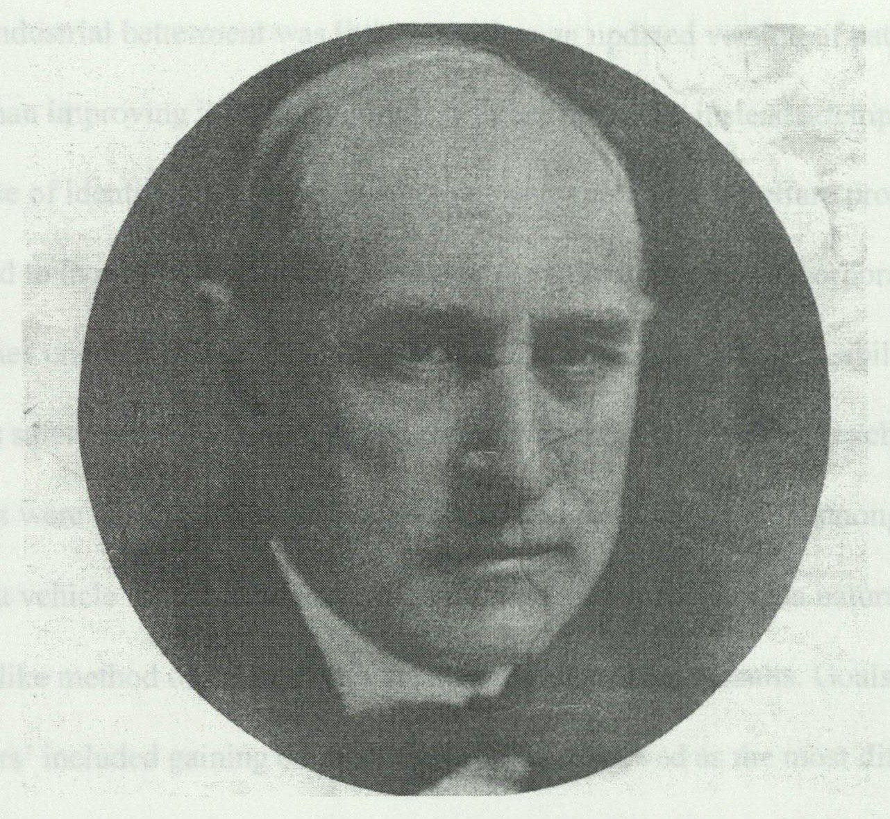 Oval portrait of Richard Hardy, bald and slightly smiling, in a dark suit