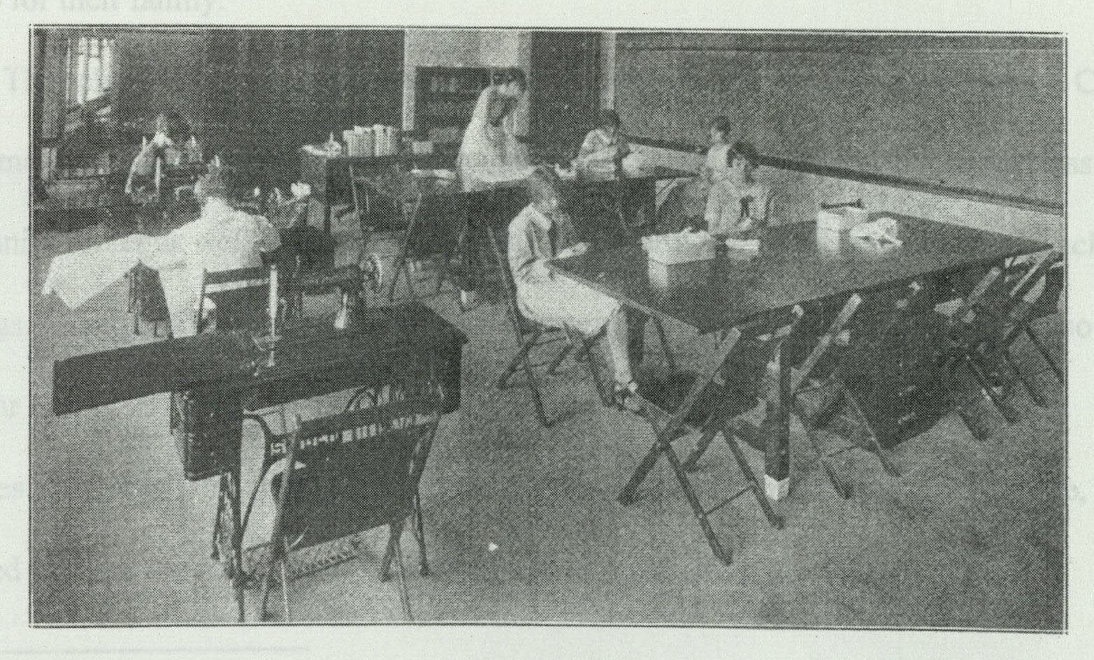 Students working at sewing machines arranged in rows in the sewing laboratory classroom
