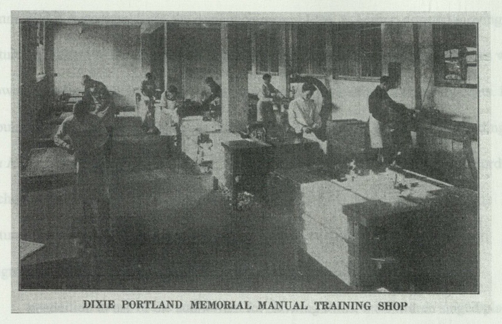 Students working at woodworking benches with hand tools and lathes in the manual training shop