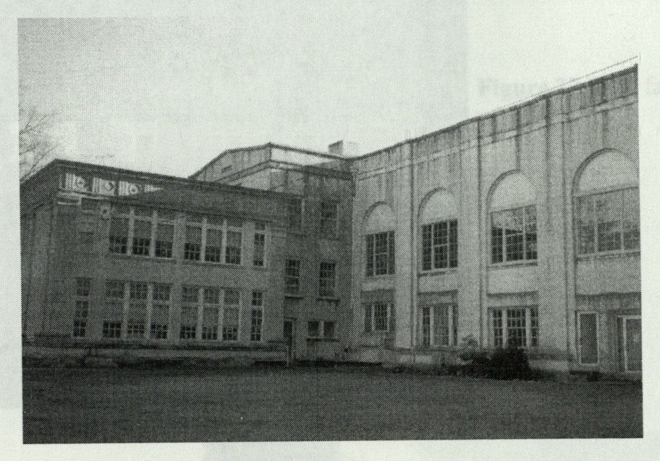 Rear facade of the left wing showing regular rows of windows and pilaster-flanked bays