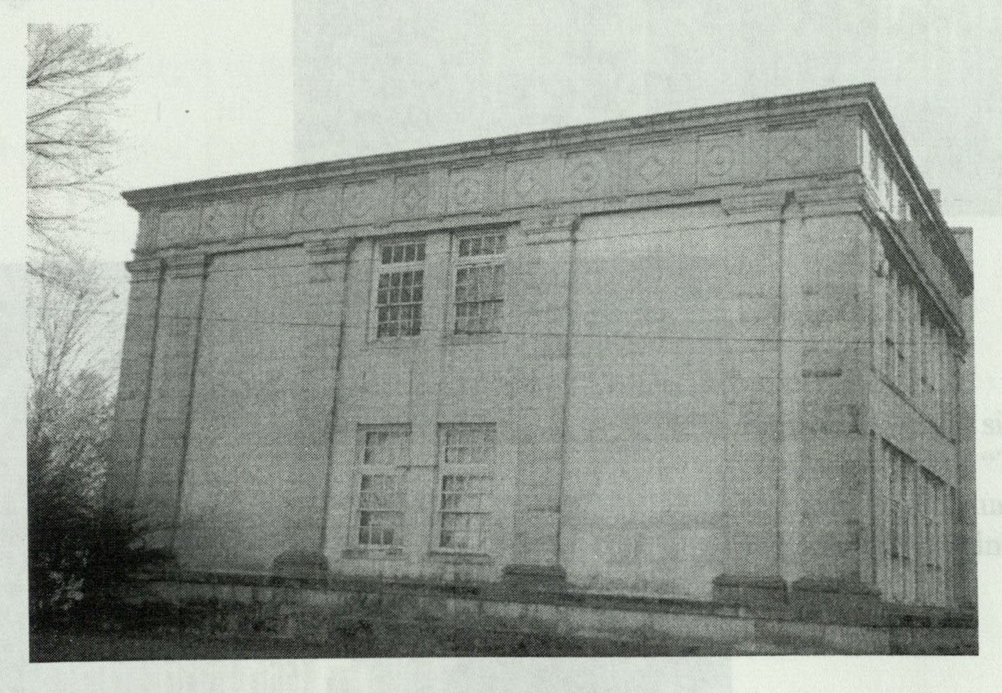 Side facade of the left wing showing three bays of sash windows with pilasters and entablature