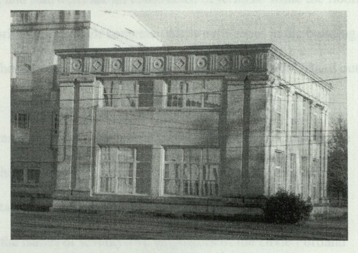 Rear facade of the right wing showing six-over-six ribbon windows at the upper level