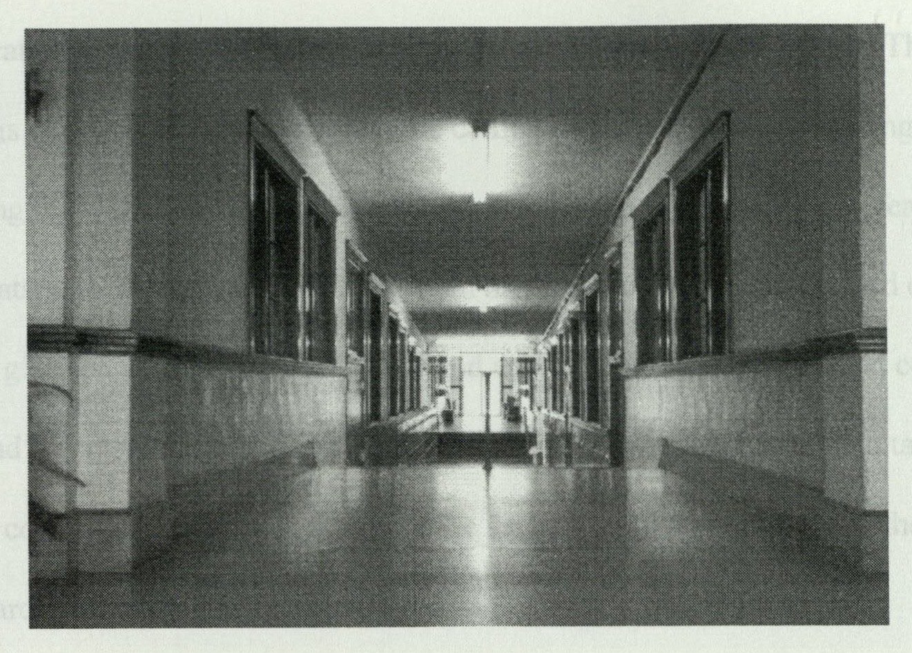 Long corridor of the first floor viewed from the memorial lobby entrance, with terrazzo floor and globed lanterns